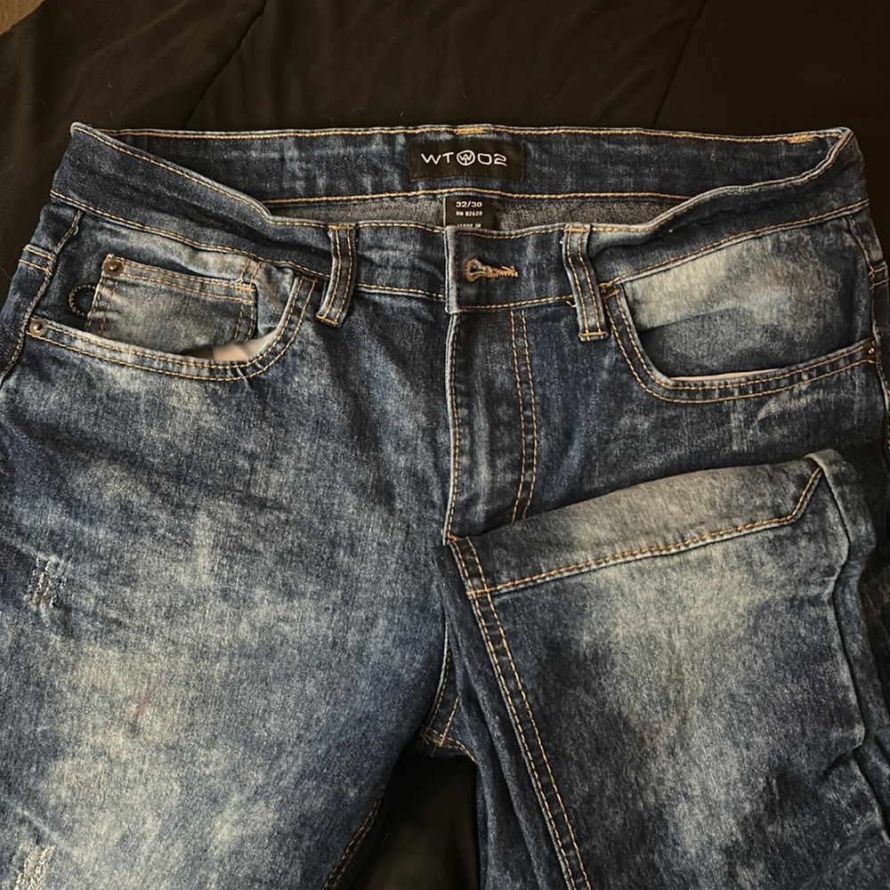 Men’s jeans patch knees faded style.